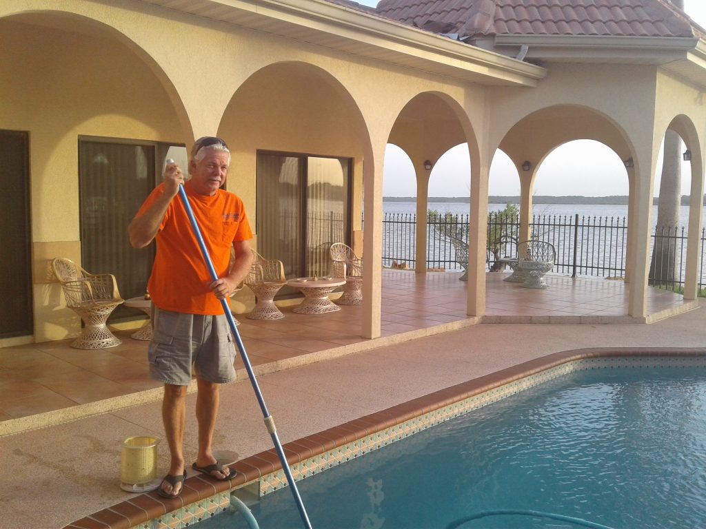 Bruce Heart cleaning a beautiful pool with a skimmer