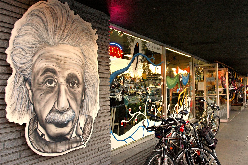 Front window of a bike shop with a mural of Albert Einstein, he did love bicycles...