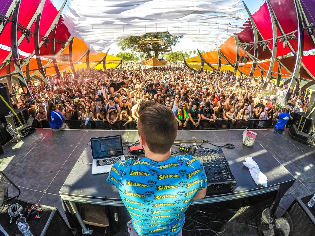 DJ on stage in front of a large audience